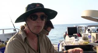 Lynda Avery on deck of the Kimberley Quest with sunglasses and hat on