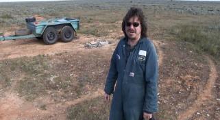 A man standing in the vast expense of the Nullarbor