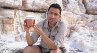 Oliver Gomez holding sponges collected from a reef