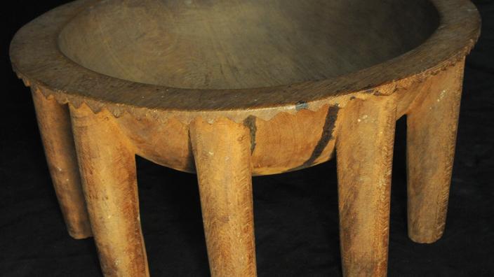 A large wooden kava bowl with many table-like legs