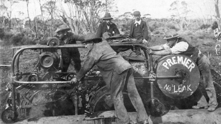 Men using an electric caulking machine, c1902