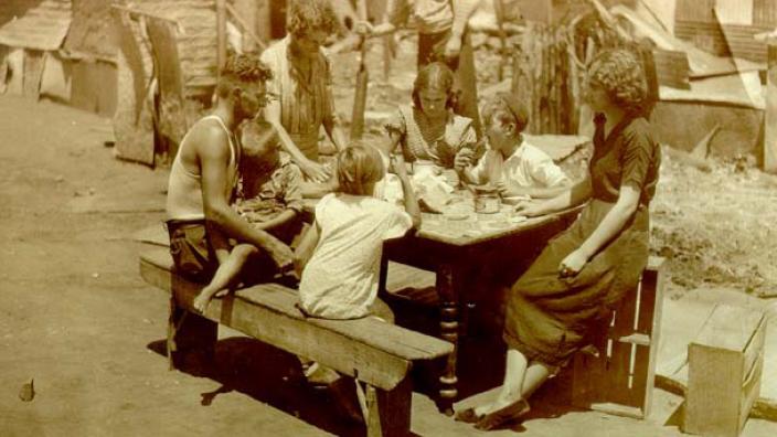 Rulyancic family sitting at a table after the Kalgoorlie riots, 1934