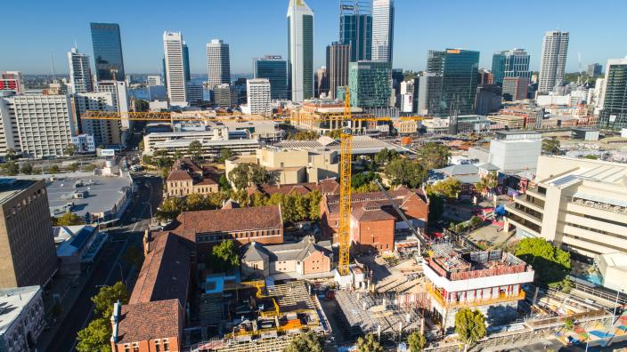 view of a construction site with city skyline in the background