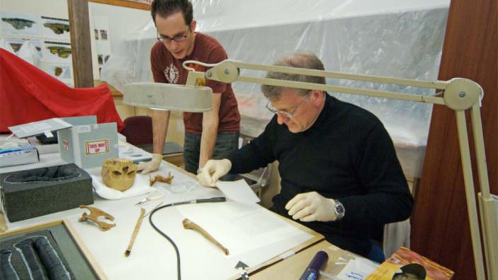 Two archaeologists at work preparing papers