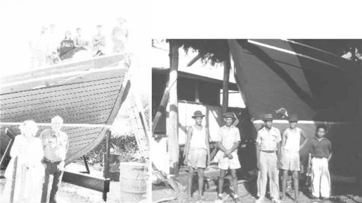 A large group of people next to the boat they built