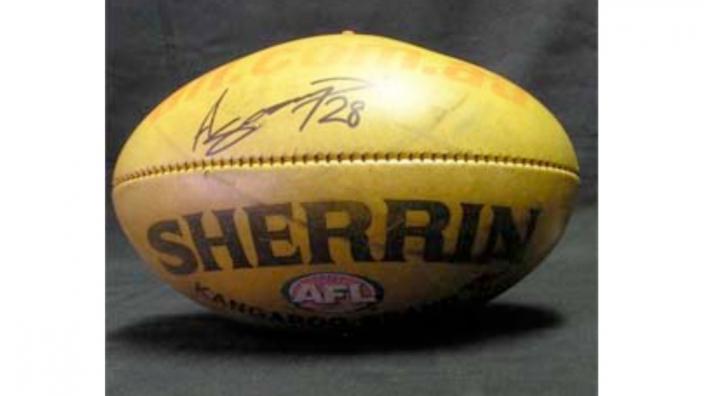 An AFL football, signed by Ashley Sampi