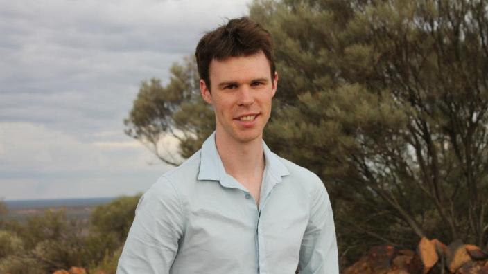 James Bednall standing in front of the vast Australian outback