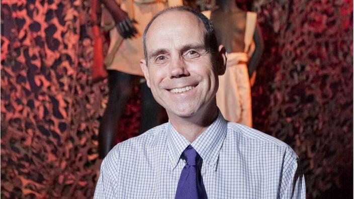 Curator Stephen Anstey standing in front of an item from the Debt of Honour exhibition