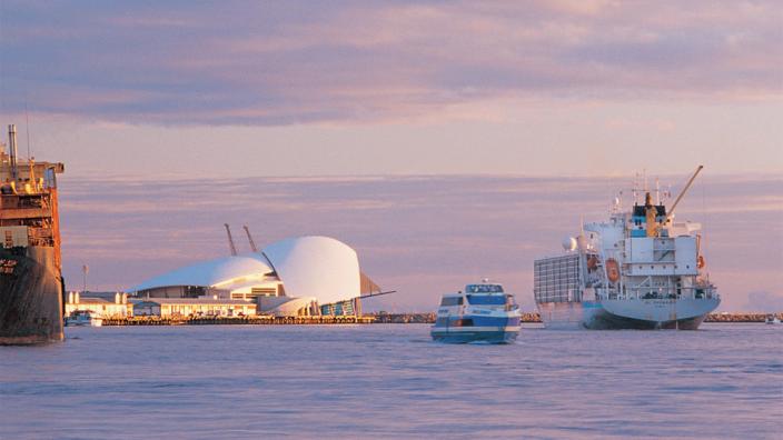 Fremantle port at sunset with a large boat entering the harbour