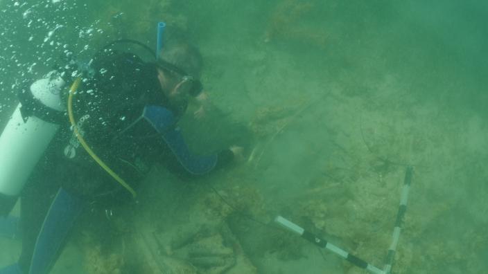 Western Australian Museum Maritime Archaeologist Michael ‘Mack’ McCarthy inspecting the wreck underwater at 7 Mile Beach