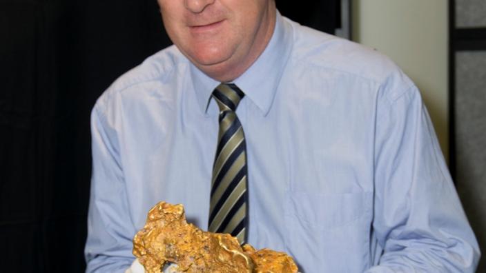 John Day holding a giant gold nugget