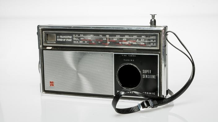 A silver and black radio adapted to conceal a camera, c1965.