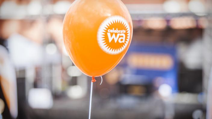An orange balloon with Celebrate WA written on it