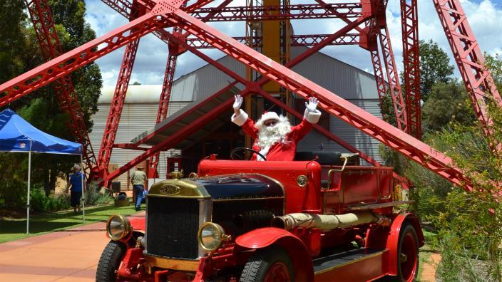 Santa sitting in an old red car in Kalgoorlie