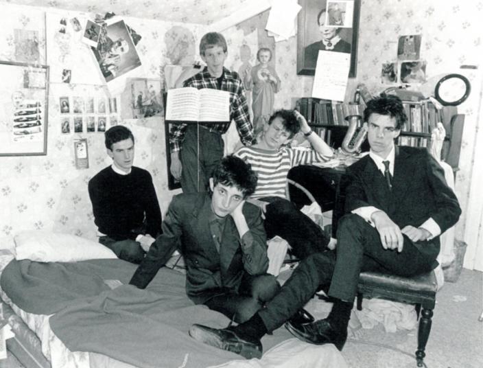 The Boys Next Door band posing together in Nick Cave's bedroom.