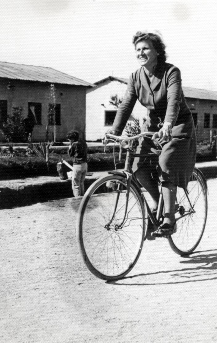 Nada's mother on a bicycle at San Antonio refugee camp