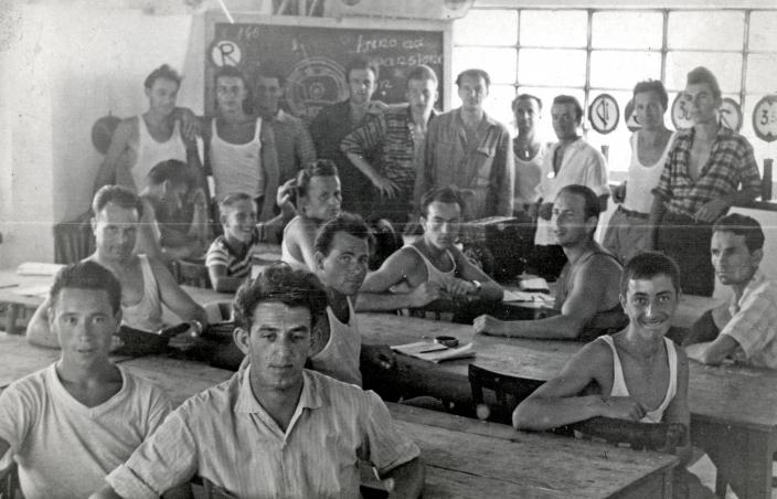 Adults sitting in a classroom in an Italian refugee camp 