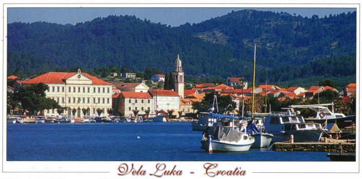 boats, buildings and rolling hills form this picturesque postcard of Vela Luka 