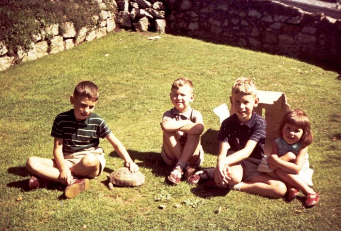 Stephen and his siblings on their backyard lawn 