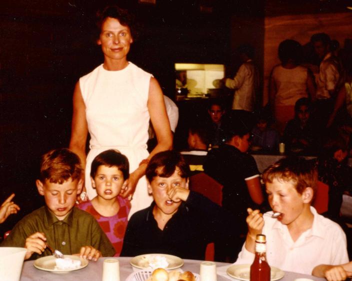 Stephen and his mother and siblings sitting in a ship dining room