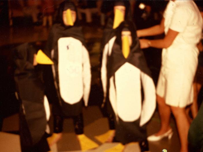 Stephen and his siblings in crepe paper penguin costumes 