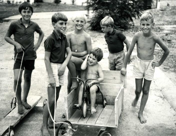 The Ansteys and other children playing with wooden carts and bikes in 1969 