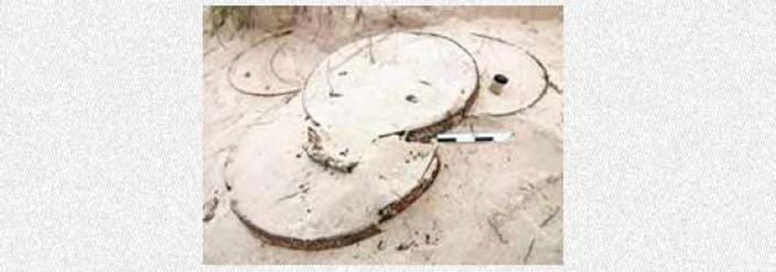 Barrel hoops partially covered in sand