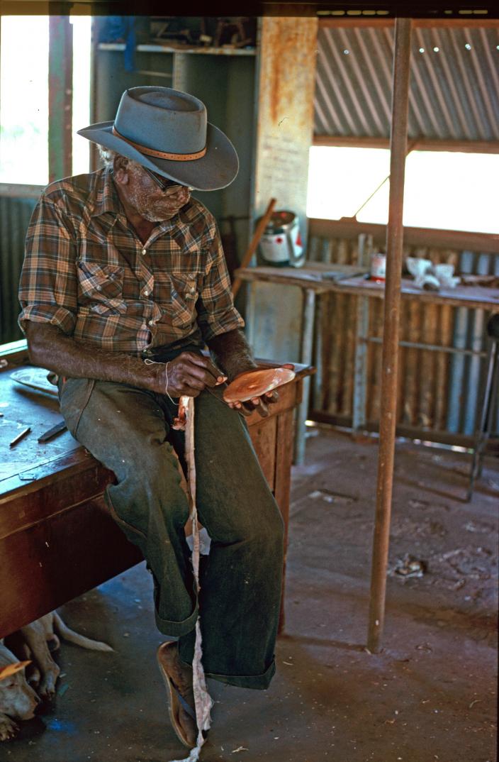 Man working with pearlshell and red ochre