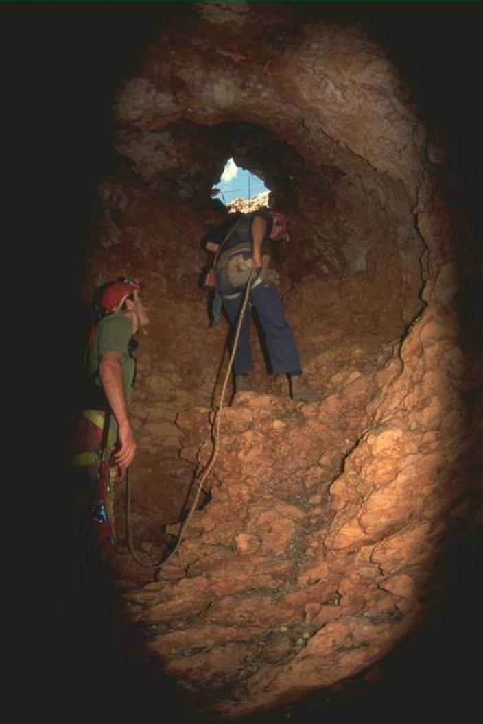 Image of a person abseiling in a cave