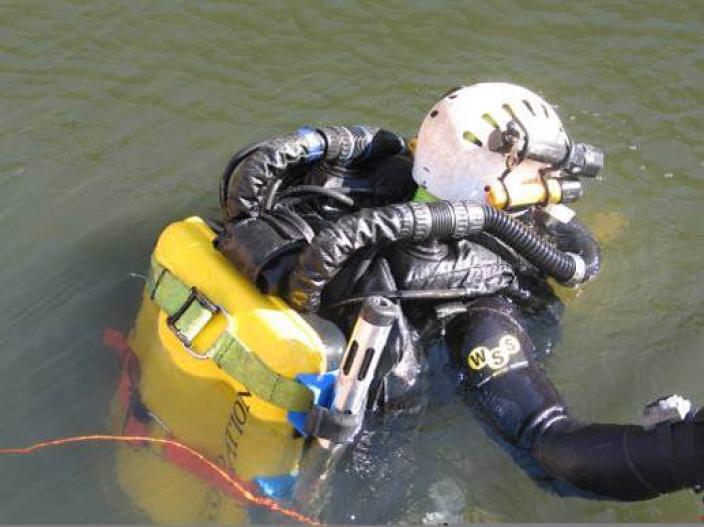 A diver sitting at the surface of the water