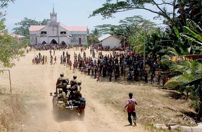 A 3 SAS Squadron vehicle mounted patrol are welcomed by East Timorese locals