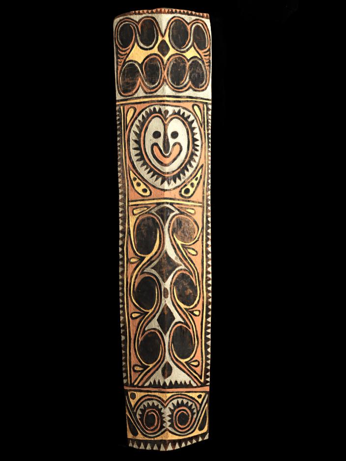 A large, colourful war shield from Kupkein, Upper Sepik. Features a smiling face