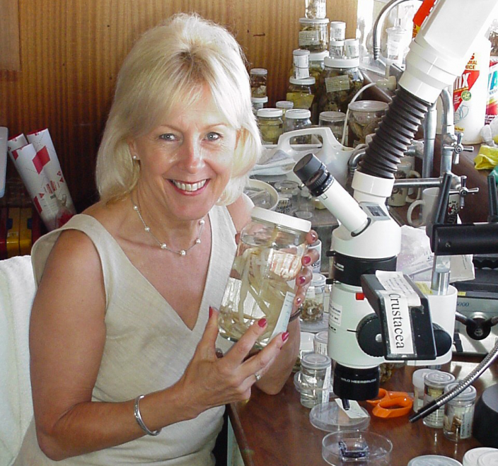 "A woman sat among jars of specimens."