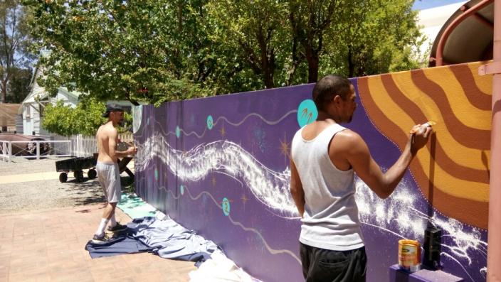 Dominique McKenzie and Desmond Cameron painting the mural
