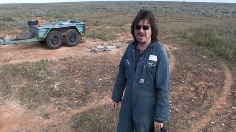 A man standing in the vast expense of the Nullarbor