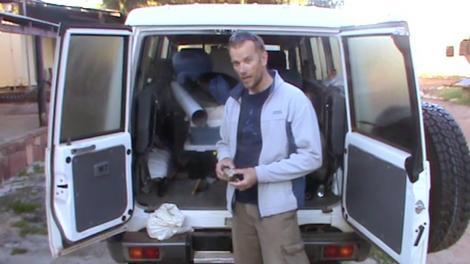 Mikael Siversson talking to camera in front of a 4WD vehicle