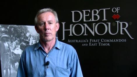 Paul Bridges standing in front of entry to the exhibition Debt of Honour