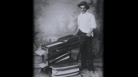 A man operating a piece of mining equipment from the 19th century