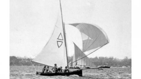 A black and white photo of a racing dinghy