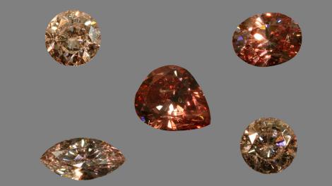 A staged photo of a series of pink diamonds