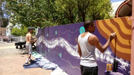 Dominique McKenzie and Desmond Cameron painting the mural