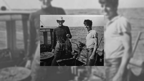 Two men in a boat fishing for crayfish