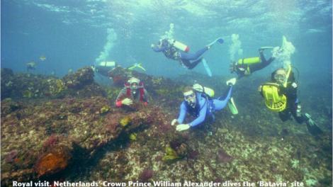 Several divers exploring a shipwreck site