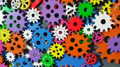 A stack of small, brightly colourful cogs