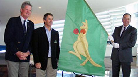 Left to Right: Former Australia II crewmen John Longley and Skip Lissiman present the Boxing Kangaroo flag to Tim Ungar, Chair of the Board of Trustees of the WA Museum.