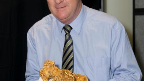 John Day holding a giant gold nugget