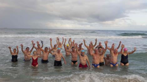 A large group of elderly people on the beach