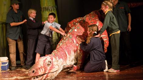 Children participating in the Erth Dinosaur Petting Zoo performance