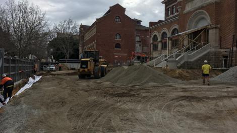 Heritage buildings in the background, dirt that has been levelled in the foreground