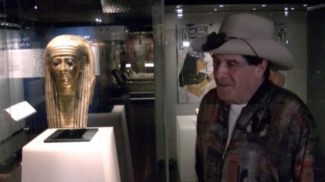 Molly Meldrum Standing next to a Egyptian gold mask